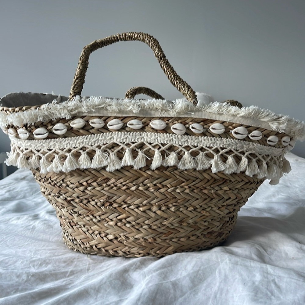 Boho straw tote bag with seashells and macrame detailing.